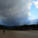 Dave under heavy cloud at Tidal River with break in the clouds